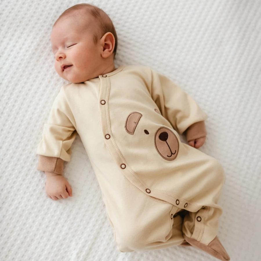 Ecru baby romper with teddy bear embroidery