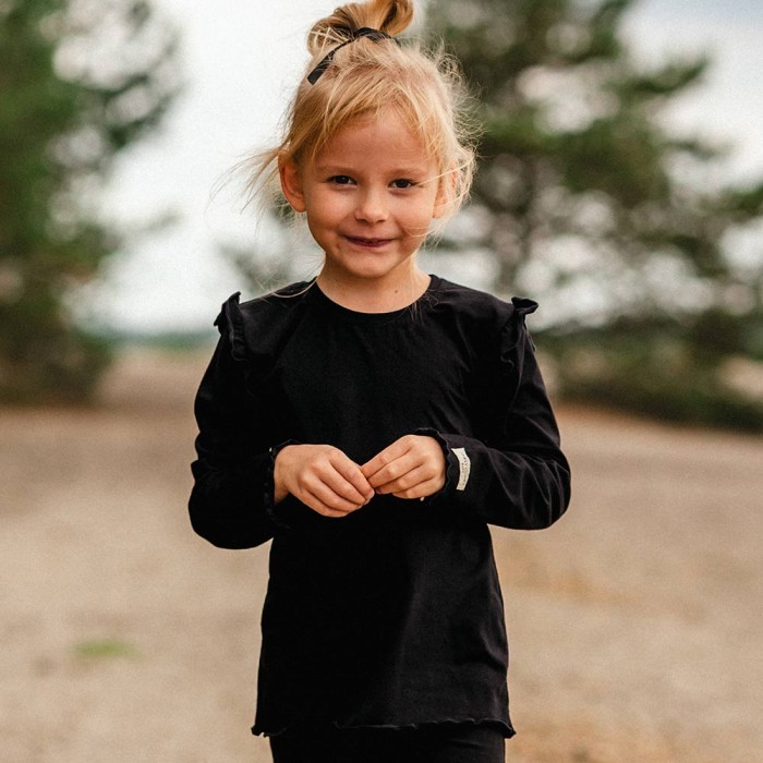 Black cotton blouse with ruffles on shoulders